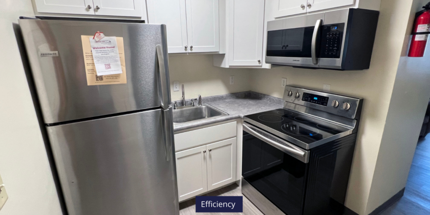 a kitchen with stainless steel appliances and white cabinets