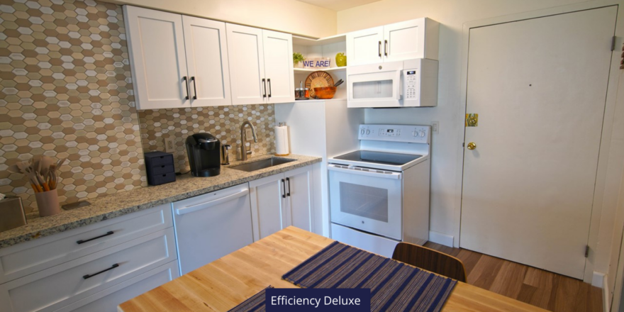 a kitchen with white cabinets and a wooden table