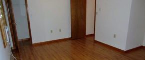 Unfurnished bedroom with window AC unit, ceiling fan, and hardwood floors