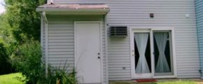 Back exterior of townhouse with sliding doors