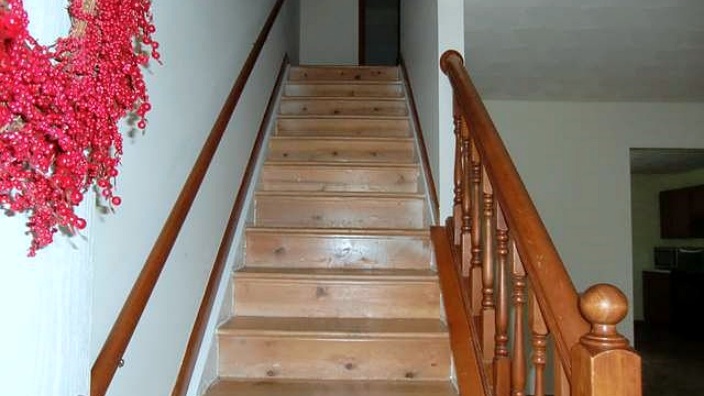Wooden staircase with handrails on both sides