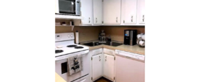 Kitchen with white cabinets and white appliances