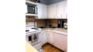 Kitchen with white cabinets and white appliances