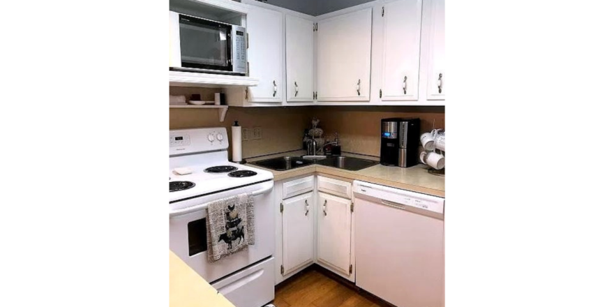 Kitchen with white cabinets and white appliances