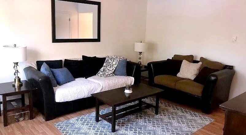 Living area with couch, love seat, and accent tables