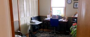 Office with area rug, chairs, and desk