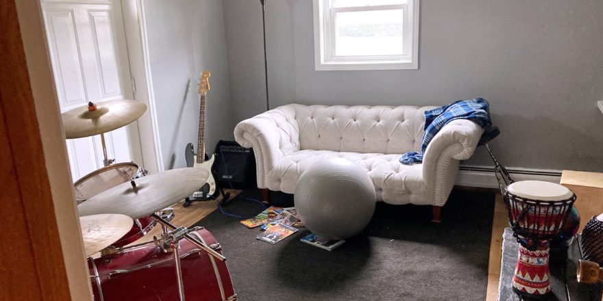 Room with couch, drum set and other instruments