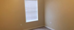 Unfurnished, carpeted bedroom with window