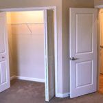 Carpeted bedroom with closet