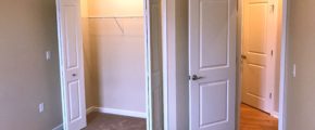 Carpeted bedroom with closet