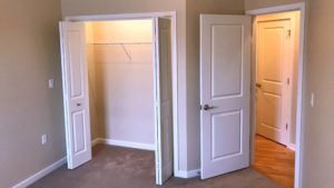 Carpeted bedroom with closet
