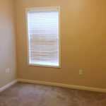 Unfurnished, carpeted bedroom with window