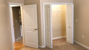 Unfurnished, carpeted bedroom with closet