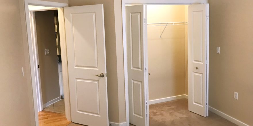 Unfurnished, carpeted bedroom with closet