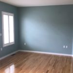 Unfurnished living room with built-in shelving, fireplace, and TV