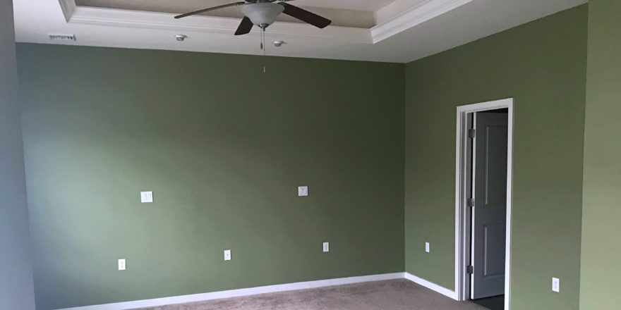 Unfurnished, carpeted owner's suite bedroom with ceiling fan