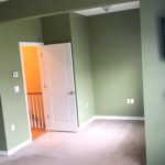 Unfurnished, carpeted owner's suite bedroom with ceiling fan, TV, and fireplace