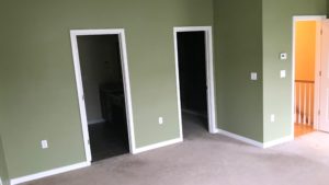 Unfurnished, carpeted owner's suite bedroom viewing into en suite bathroom and walk in closet
