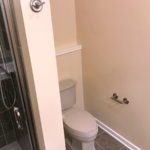 Shower stall with tile and sliding glass door and toilet
