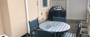 Fenced-in patio with furniture and grill
