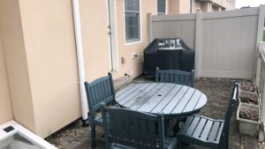 Fenced-in patio with furniture and grill