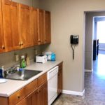 Kitchenette with sink, dishwasher, and cabinets