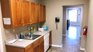 Kitchenette with sink, dishwasher, and cabinets