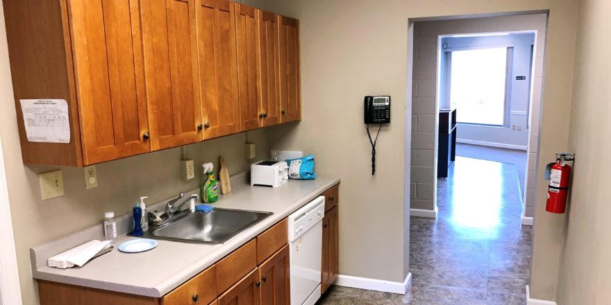 Kitchenette with sink, dishwasher, and cabinets