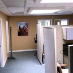 Office space area with cubicles and coat rack