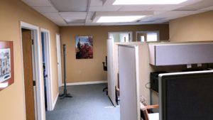 Office space area with cubicles and coat rack