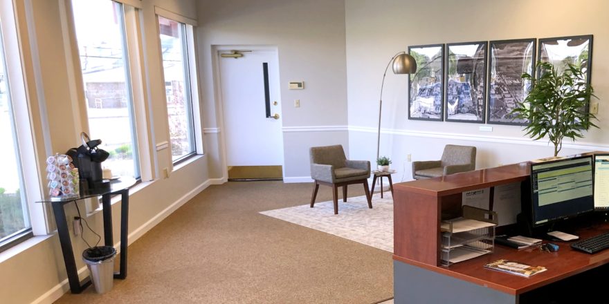 Reception area with front desk, coffee station, and seating