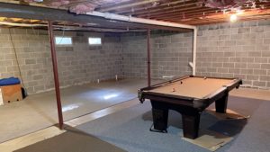 Unfinished basement with pool table