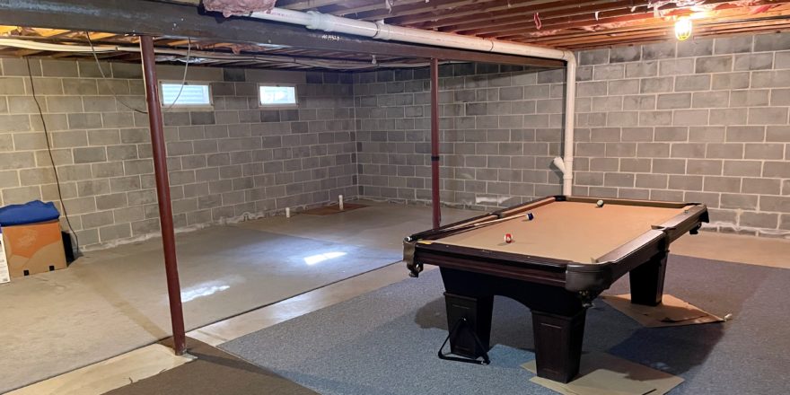 Unfinished basement with pool table