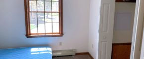 Bedroom with window, closet, and bed