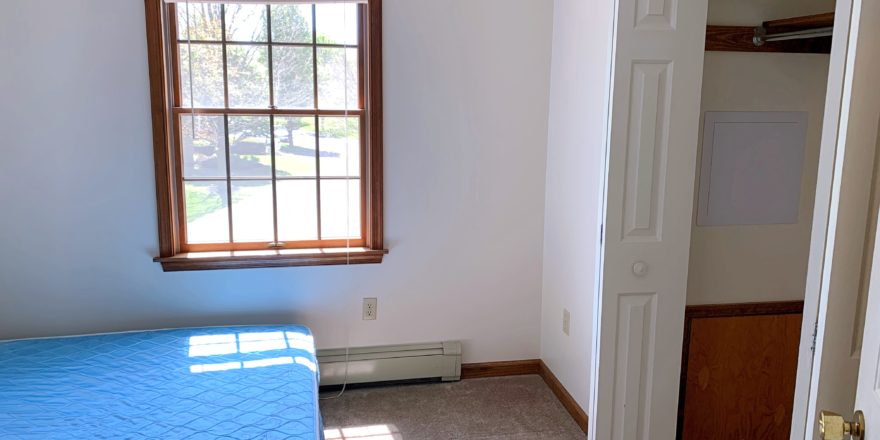 Bedroom with window, closet, and bed