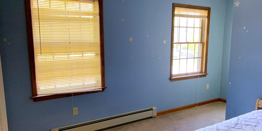 Bedroom with windows and bed
