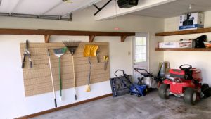 Garage with shelving and gardening equipment