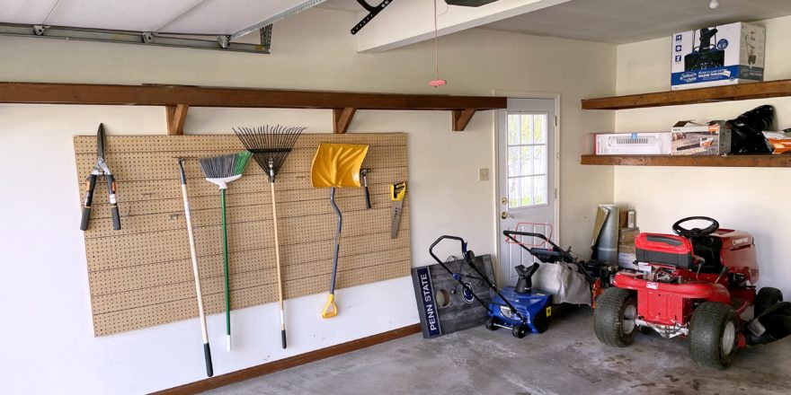 Garage with shelving and gardening equipment