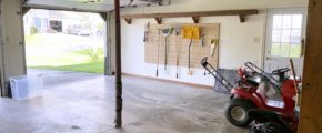 Garage with shelving and gardening equipment