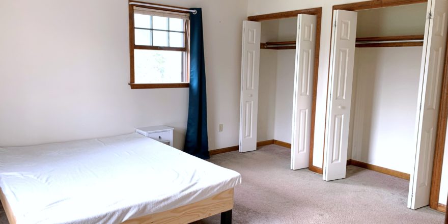 Bedroom with bed and closets
