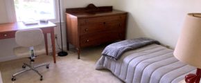 Bedroom with bed, dresser, desk, and chair