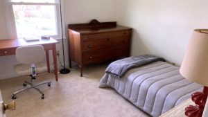 Bedroom with bed, dresser, desk, and chair