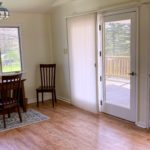 a dining room table and chairs in front of a sliding glass door