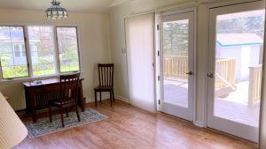 a dining room table and chairs in front of a sliding glass door