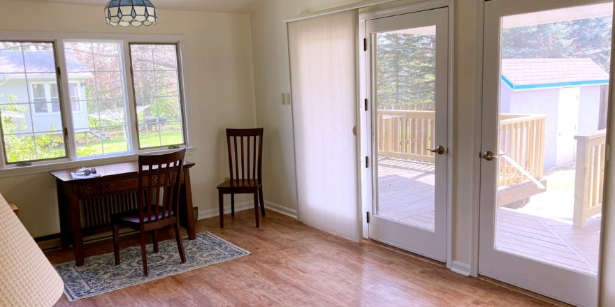 a dining room table and chairs in front of a sliding glass door