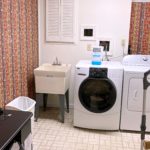 Laundry room with sink, washer, dryer, and ironing board