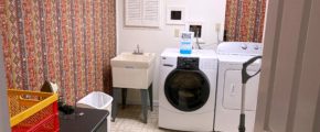 Laundry room with sink, washer, dryer, and ironing board