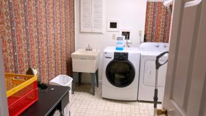 Laundry room with sink, washer, dryer, and ironing board