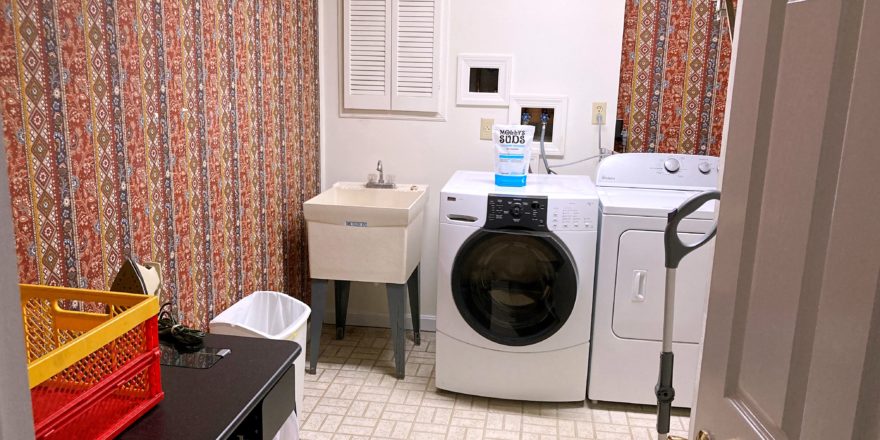 Laundry room with sink, washer, dryer, and ironing board