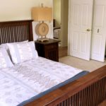 Bedroom with bed, nightstand, dresser, and closet